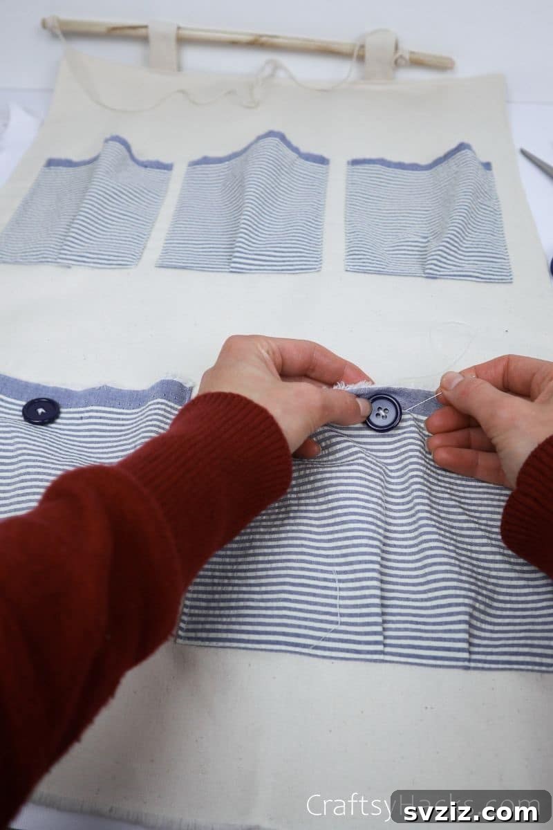Attaching decorative buttons to the pockets of the DIY organizer