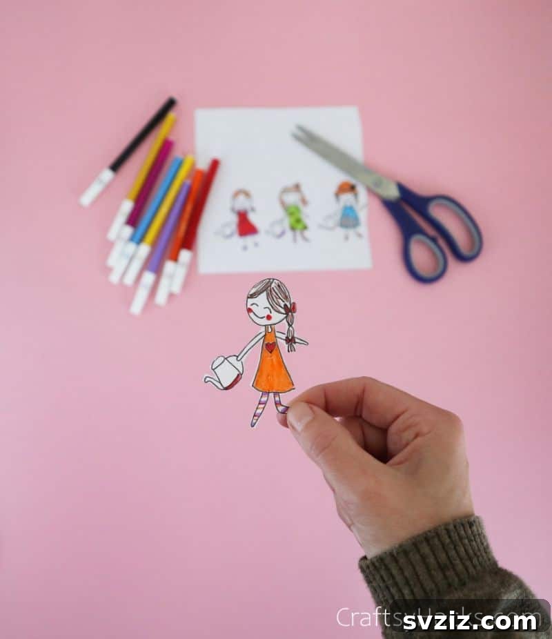 cut out of people drawings being glued to paper plate