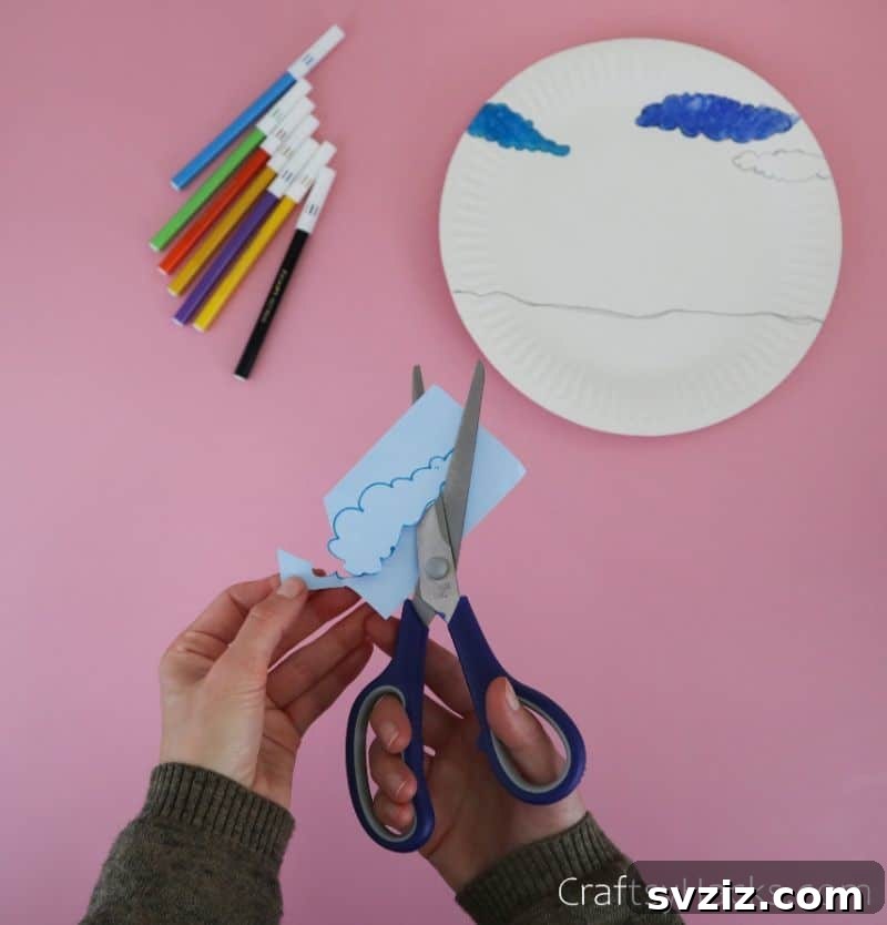 cutting out cloud shapes from paper