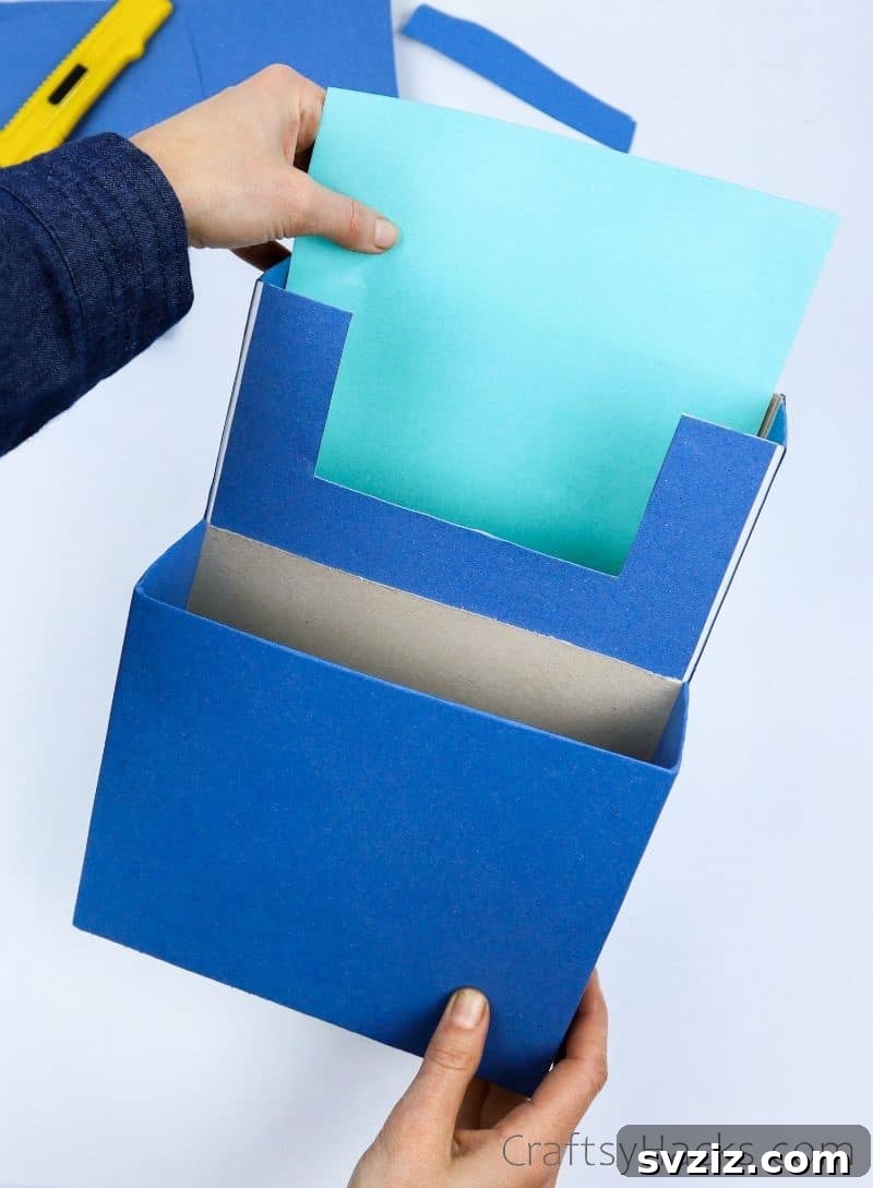 adding teal paper to inside of box