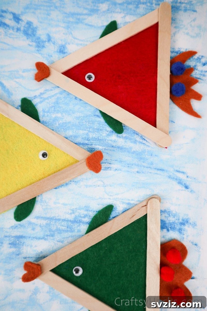 Simple Fish Crafts Kids Love to Make at School 17 Several finished fish crafts displayed against a bright blue background, resembling an underwater scene.