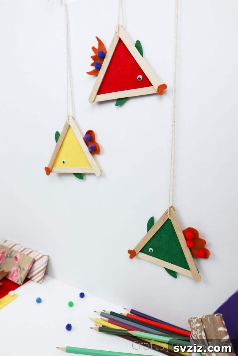 Simple Fish Crafts Kids Love to Make at School 18 Three hanging fish crafts, showcasing their colorful designs and easy display.