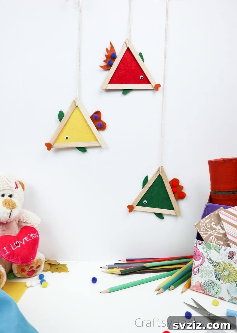Simple Fish Crafts Kids Love to Make at School 4 Several finished fish crafts hanging decoratively on a wall, showcasing their vibrant colors.