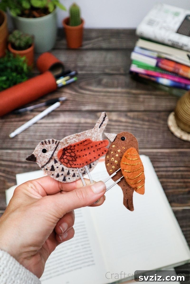 Creative Paper Clip Bookmarks 20 A hand holding two finished felt bird bookmarks with different color combinations