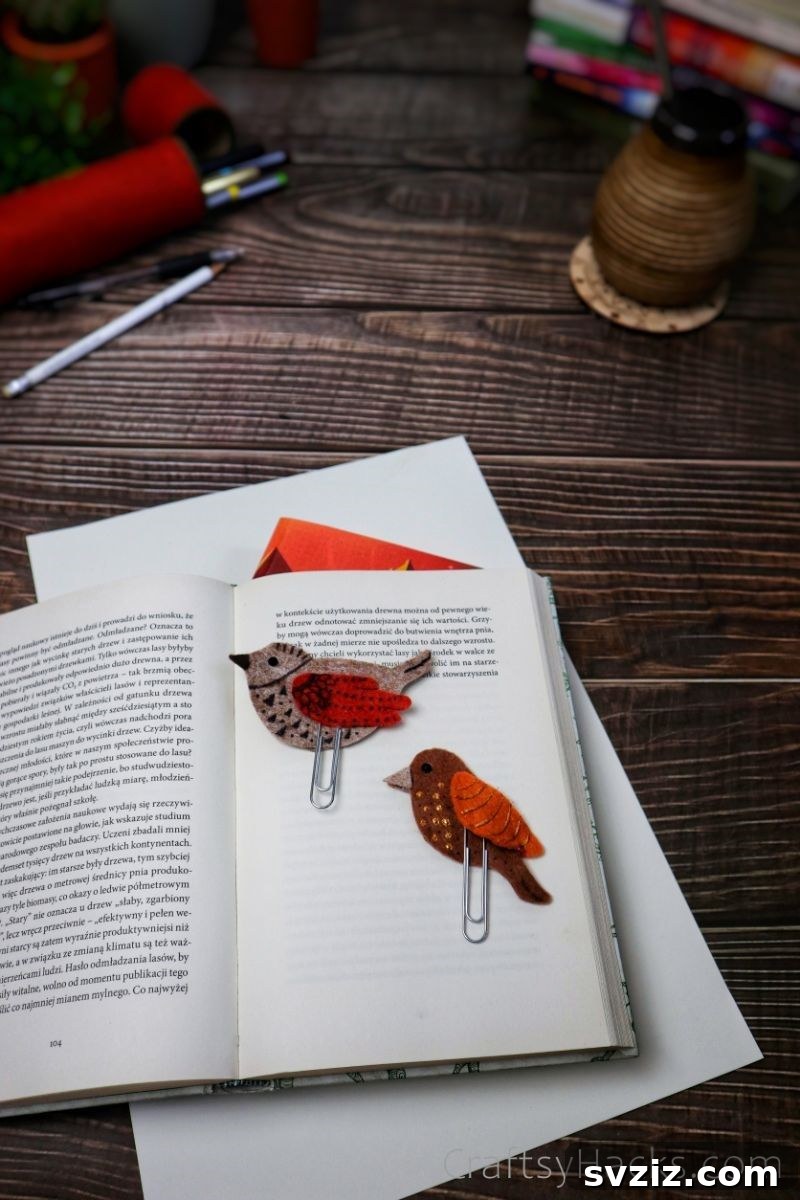 Creative Paper Clip Bookmarks 21 Two finished felt DIY bird bookmarks nestled in the pages of an open book