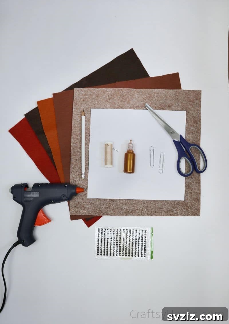 Creative Paper Clip Bookmarks 5 A flat lay showing all the craft supplies needed to make felt bird bookmarks: felt sheets, scissors, paper clips, glue gun, and glitter glue