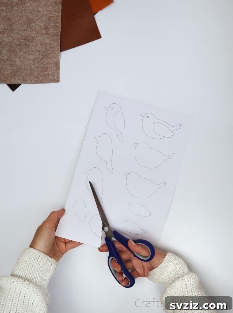 Creative Paper Clip Bookmarks 7 A hand cutting out a paper bird template with scissors