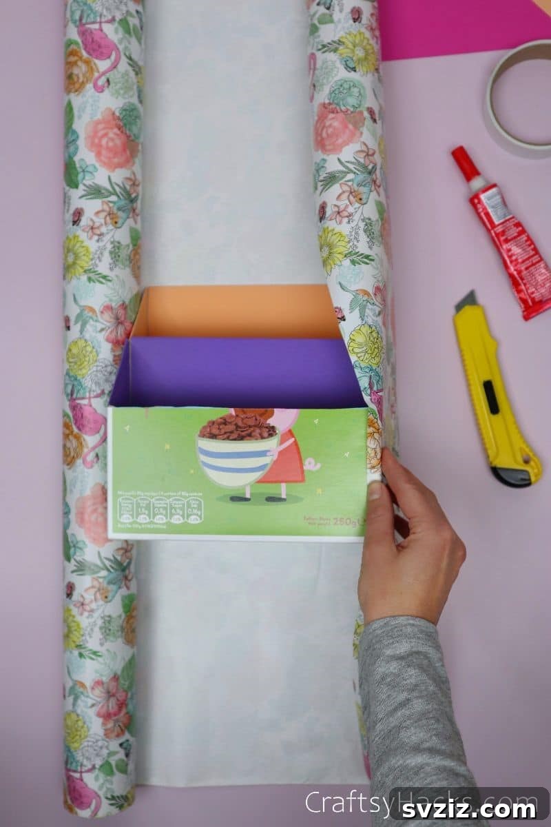 Wrapping the assembled cereal boxes with decorative paper for a superb desk organizer