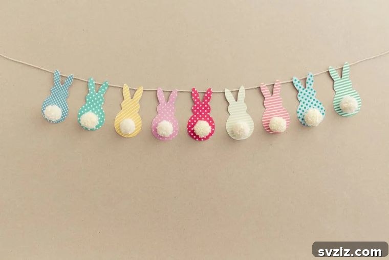 Creative Easter Projects for Adults 16 A colorful Easter garland featuring pastel paper bunnies with fluffy white pom-pom tails.