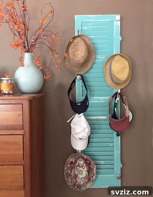 Upcycled shutter hat rack, vintage home decor with unique doorknob hooks.