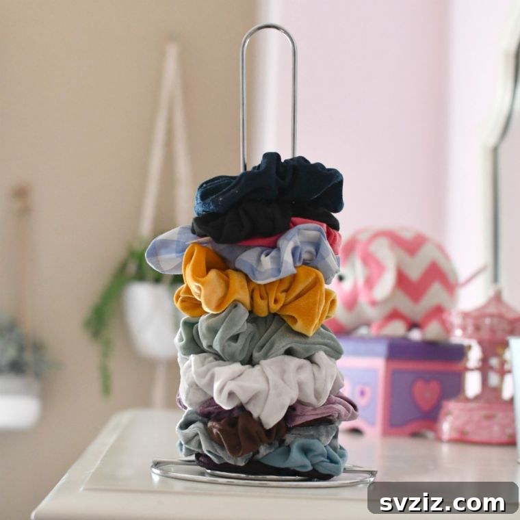 Repurposed paper towel holder for scrunchie organization