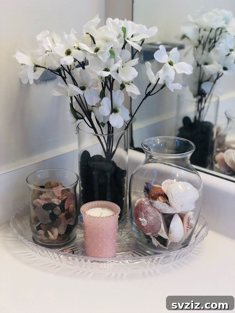 Elevated bathroom décor with glass jars and tray