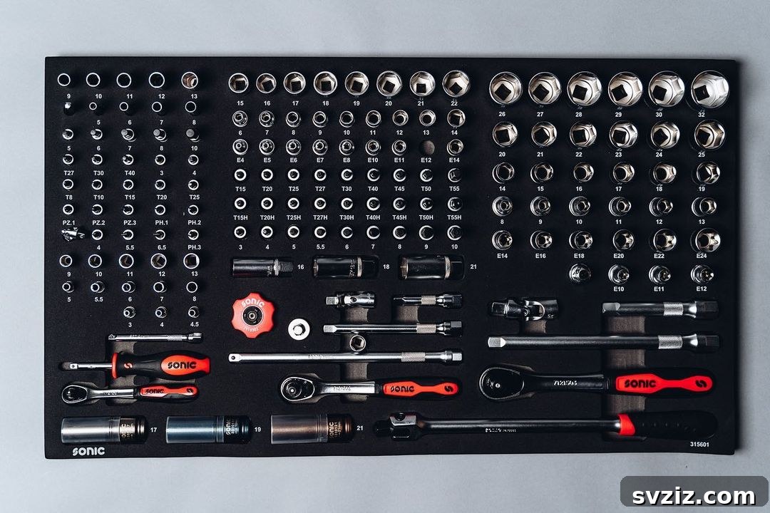 Toolbox drawer organized with foam board cutouts for small tools