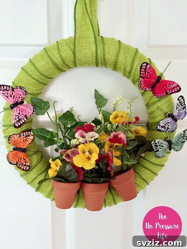 Summer Door Magic: 27 DIY Wreath Creations 19 Vibrant Wreath of Green with terracotta pots and butterflies