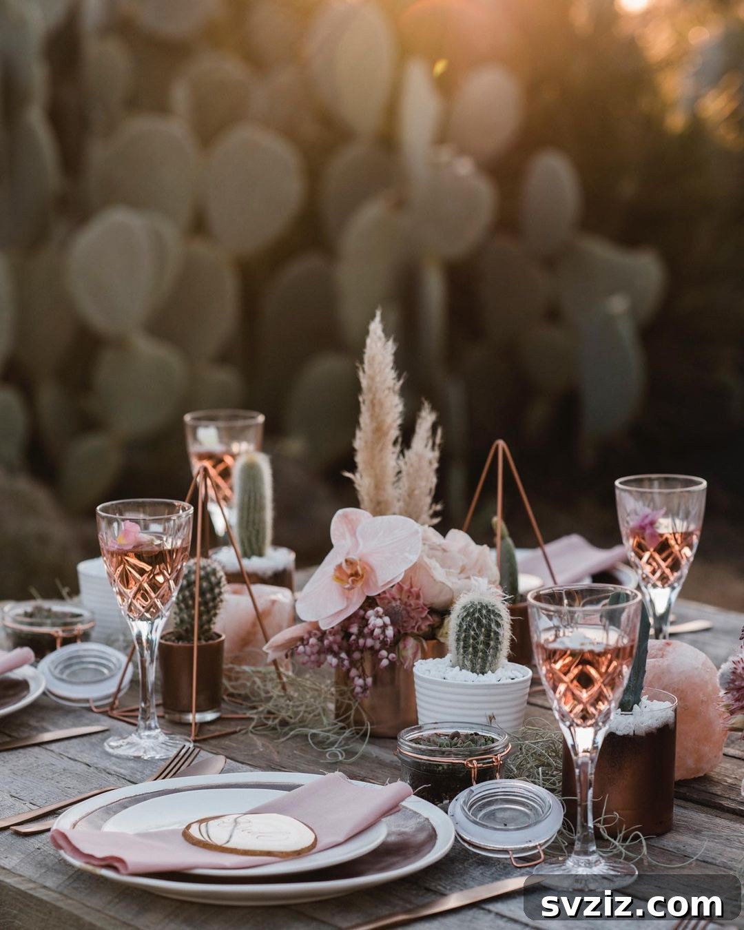 Bohemian wedding table with earthy succulents, mellow pink flowers, and reed grass accents.