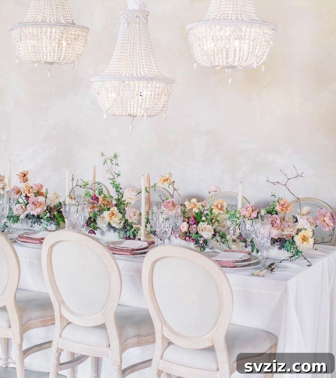 Luxurious wedding table featuring crystal chandeliers and whimsical pastel decor.