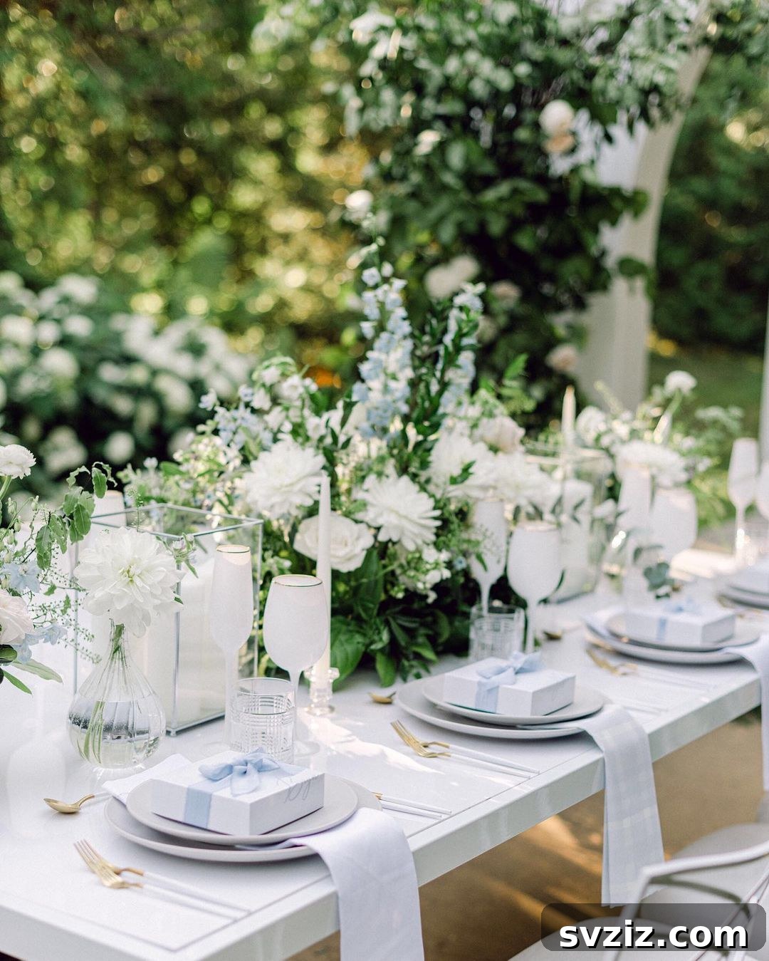 Wedding table with elegant bow-wrapped gift boxes as party souvenirs, matching floral centerpieces.