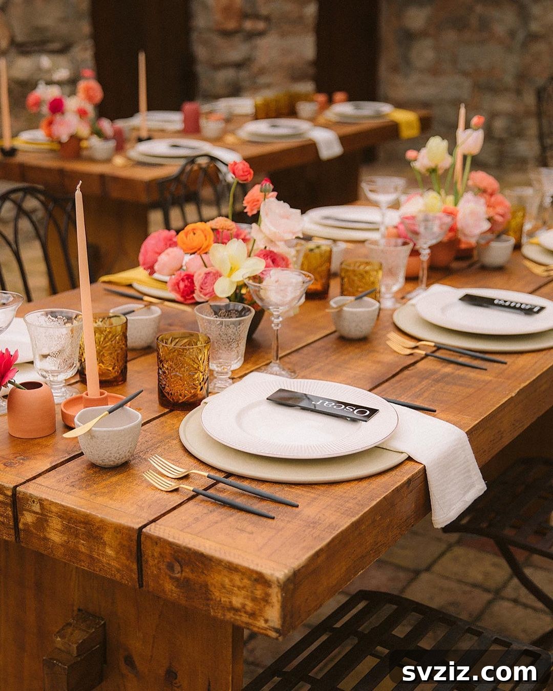 Vibrant Summer Wedding Table Decor with bright flowers on a dark wood table.